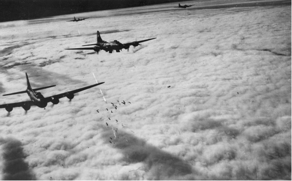 B-17 bombers flying in formation over complete cloud cover