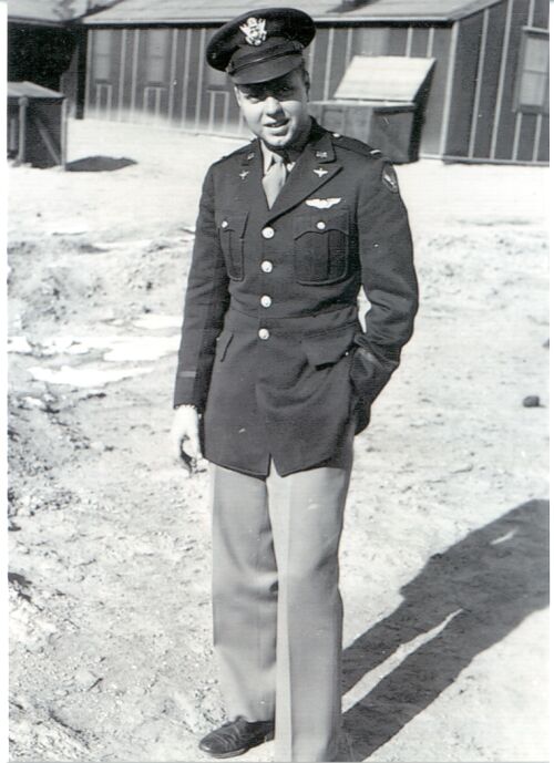 old, black and white picture of a young man in an air force uniform standing outdoors in winter